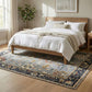Bedroom with wooden bed, white bedding, and a decorative rug.