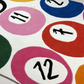 Colorful circular patterns with numbers and symbols on a textured surface