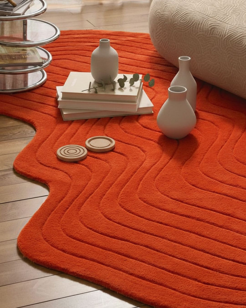 Orange textured rug with decorative items on a wooden floor