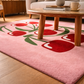 Pink rug with red floral design in a living room setting