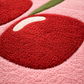 Close-up of a textured red heart shape on a pink background