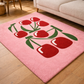 Pink rug with red tulip design on a wooden floor