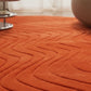 Close-up of an orange textured rug with a blurred background