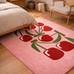 Pink rug with red tulip design in a bedroom setting