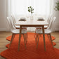 Dining room with a round orange rug, white chairs, and a wooden table.