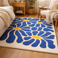 Living room with a blue floral rug on wooden flooring