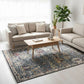 Living room with beige sofa, wooden coffee table, and patterned rug.