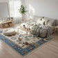 Living room with a floral rug, sofa, coffee table, and decorative items.