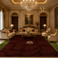 An ornate luxury living room featuring a large deep red patterned area rug with a white floral motif in the center. The room is decorated with gold-trimmed cream sofas, armchairs, a wooden coffee table, and a large crystal chandelier.