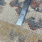 Ruler on a patterned carpet to measure its width
