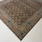 Decorative rug with intricate patterns on a white floor