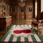 Luxurious room with wooden walls, a chandelier, and a decorative rug with cherries.