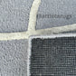 A rug with raised patterns resembling elegant arches