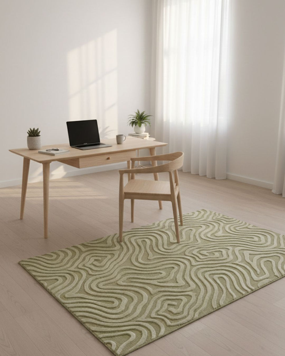 Modern home office with a desk, chair, and green patterned rug.