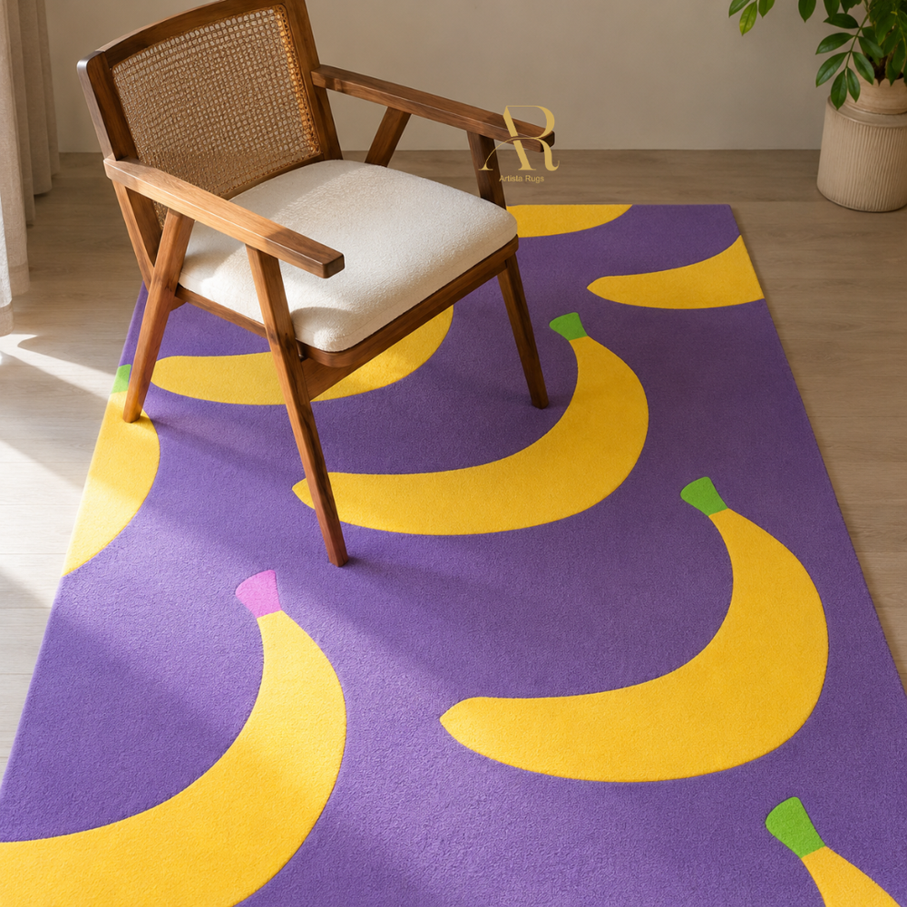 A purple area rug with a bold yellow banana pattern, styled in a bright room with a wooden armchair and a potted plant.