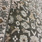Close-up of a patterned rug with geometric and floral designs.