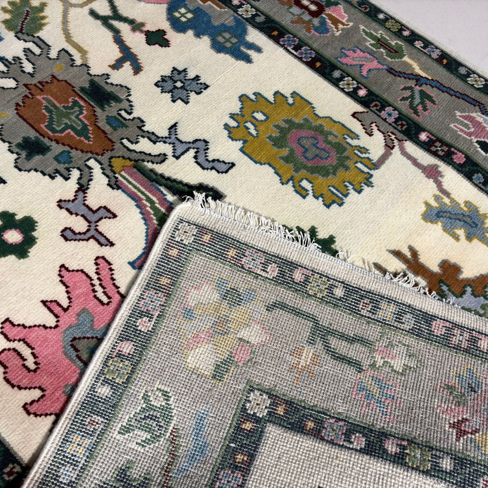Close-up of patterned rugs with intricate designs on a neutral background