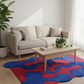 Living room with a beige sofa, wooden coffee table, and colorful abstract rug.