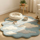 Cloud-patterned rug on a wooden floor with a small table and plant in the background.