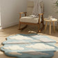 Rug with cloud design in a room with a rocking chair and side table.