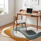 Modern home office with wooden desk, chair, and colorful rug.