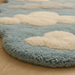Round cloud-patterned rug on a wooden floor
