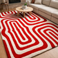 Living room with a red and white patterned rug, beige sofa, and wooden coffee table.
