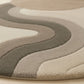 Close-up of a patterned rug with wavy design on a beige background