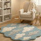 Rug with cloud design in a room with a chair and bookshelf.