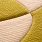 Close-up of a textured green and beige rug