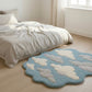 Bedroom with a cloud-patterned rug on a wooden floor