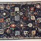 Close-up of an ornate rug with intricate patterns on a dark blue background