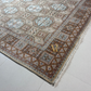 Decorative rug with intricate patterns on a light gray floor