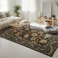 Living room with a decorative rug, coffee table, and sofa.