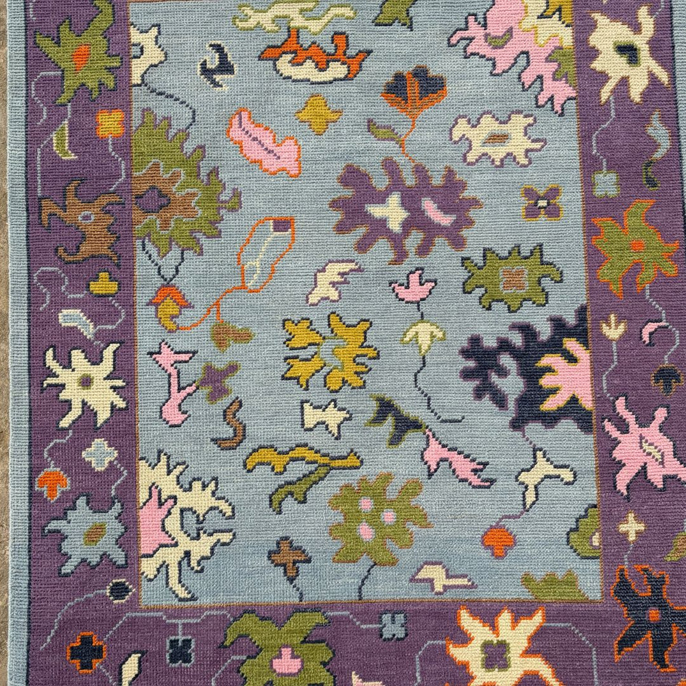 Colorful patterned rug with floral designs on a blue background