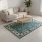 Living room with a beige sofa, coffee table, and blue patterned rug.