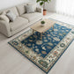 Living room with a blue patterned rug, beige sofa, and wooden coffee table.