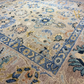 Close-up of a patterned rug with floral and geometric designs.