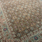 Close-up of a patterned rug with intricate designs and colors.