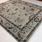 Decorative rug with intricate patterns on a white floor