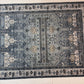 Decorative rug with geometric pattern on a light wood floor