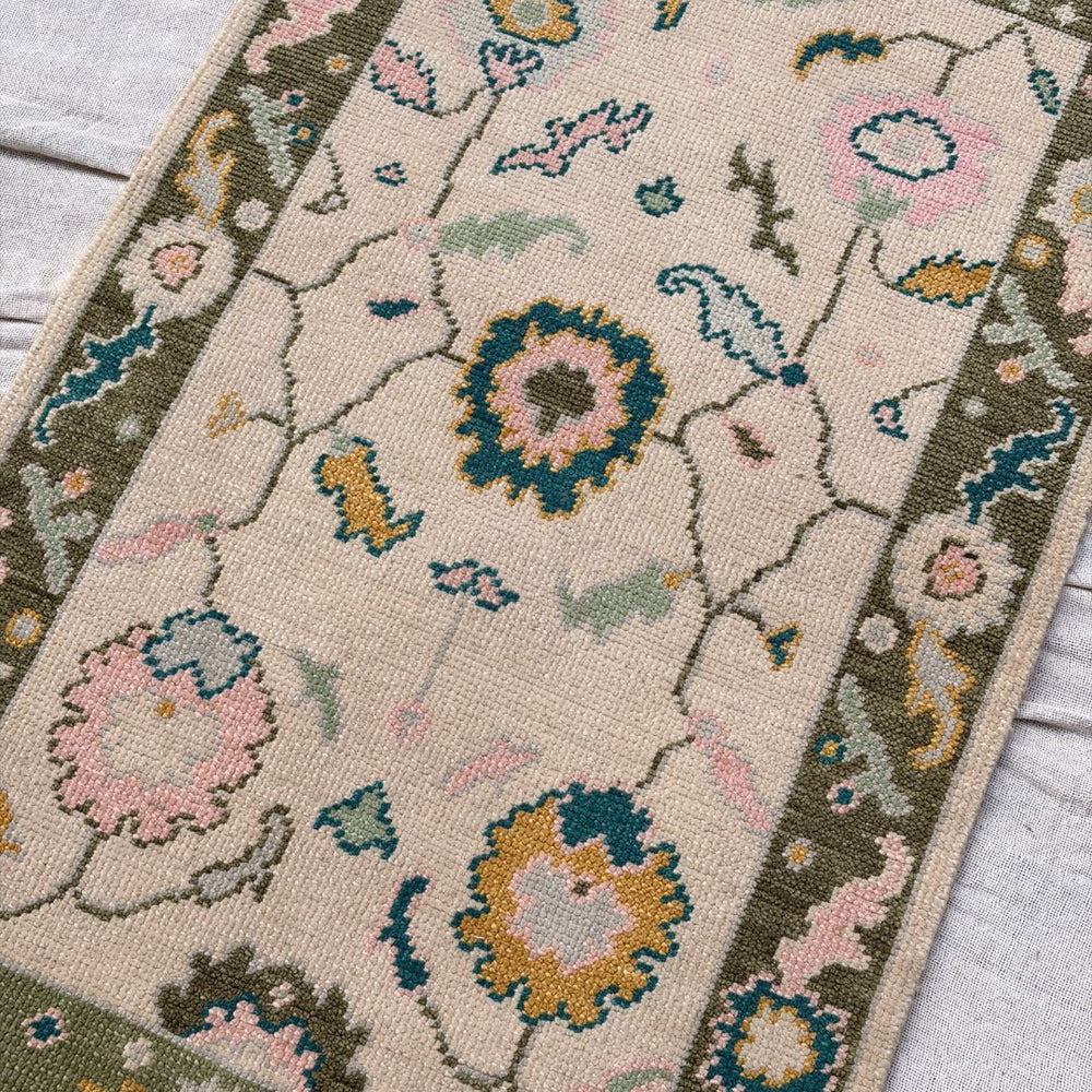 Floral patterned rug with colorful flowers on a neutral background