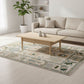 Living room with a beige sofa, wooden coffee table, and patterned rug.