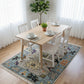 Dining room with a wooden table set for a meal on a decorative rug.