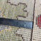 Rug with a ruler for scale showing its size
