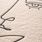 Close-up of a textured surface with a black line drawing of a face.