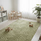 Green patterned rug in a room with children's furniture and decor.