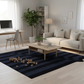 Modern living room with a navy blue rug, beige sofa, and wooden coffee table.