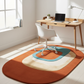 Modern home office with a wooden desk, chair, and colorful rug.
