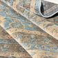 Close-up of a patterned rug with earthy tones.